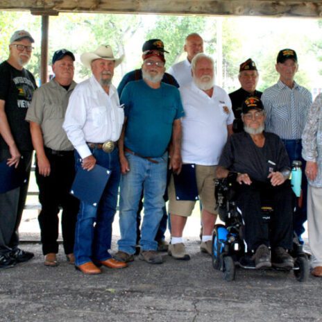 These local vets were honored by Rep. Dusty Johnson. From the left, Dennis Baer, John Swede, Randy Shaw, Fred Wells, Nila Charles, Martin Scott, Larry Rogers, William Moldenhauer, Ed Humble, Charles Harrison, Arlan Emmert, Martin Anderson, Dave Baumiller, Andy Howie (seated), Miles Reed, the wife of Don Scheurenbrand, Andy Anderson, Peter Bonnichsen, Myan Charles, and Rep. Dusty Johnson. Photo by Betty Bruner
